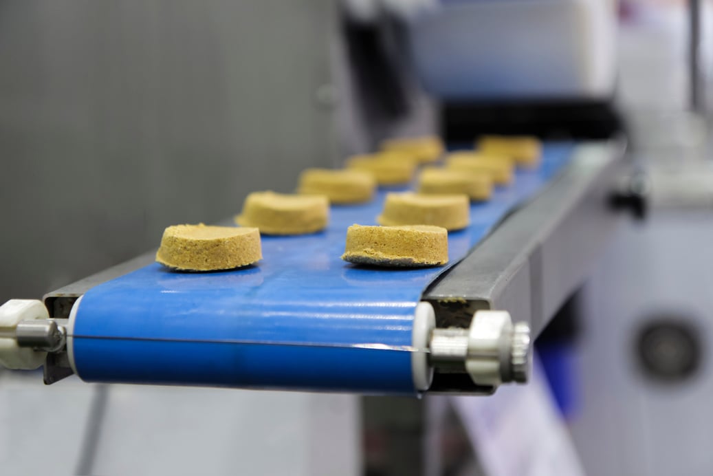 a conveyor belt with food items on it