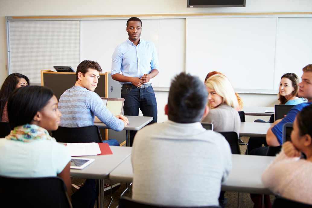 a Food Safety Training provider standing in front of a group of students who happen to be food handlers/ chefs/ supervisors in food factories in a classroom, conducting food safety training