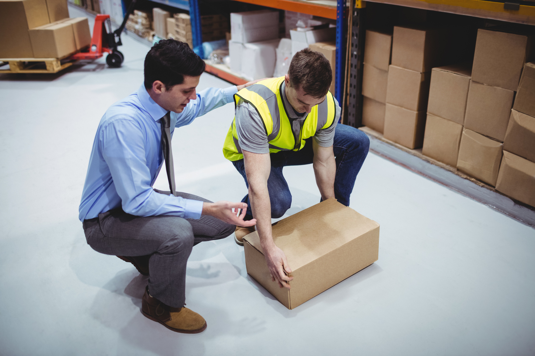 Health & Safety Trainer at work, giving the new worker training in manual handling at work. 