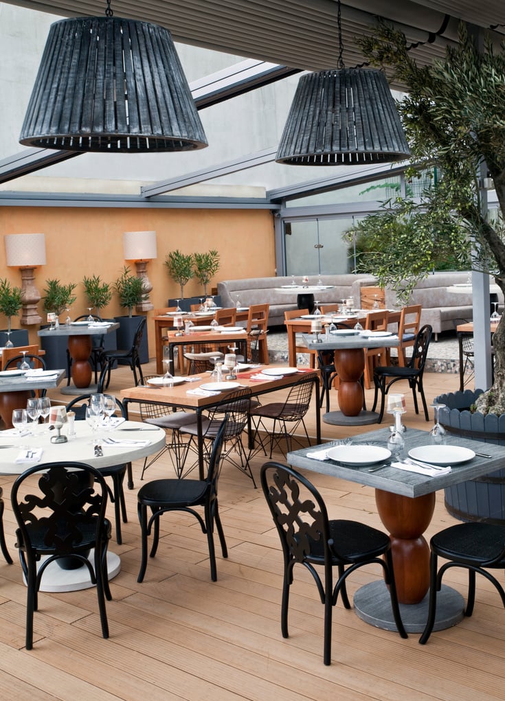 A Halal restaurant's, outdoor dining area with tables and chairs